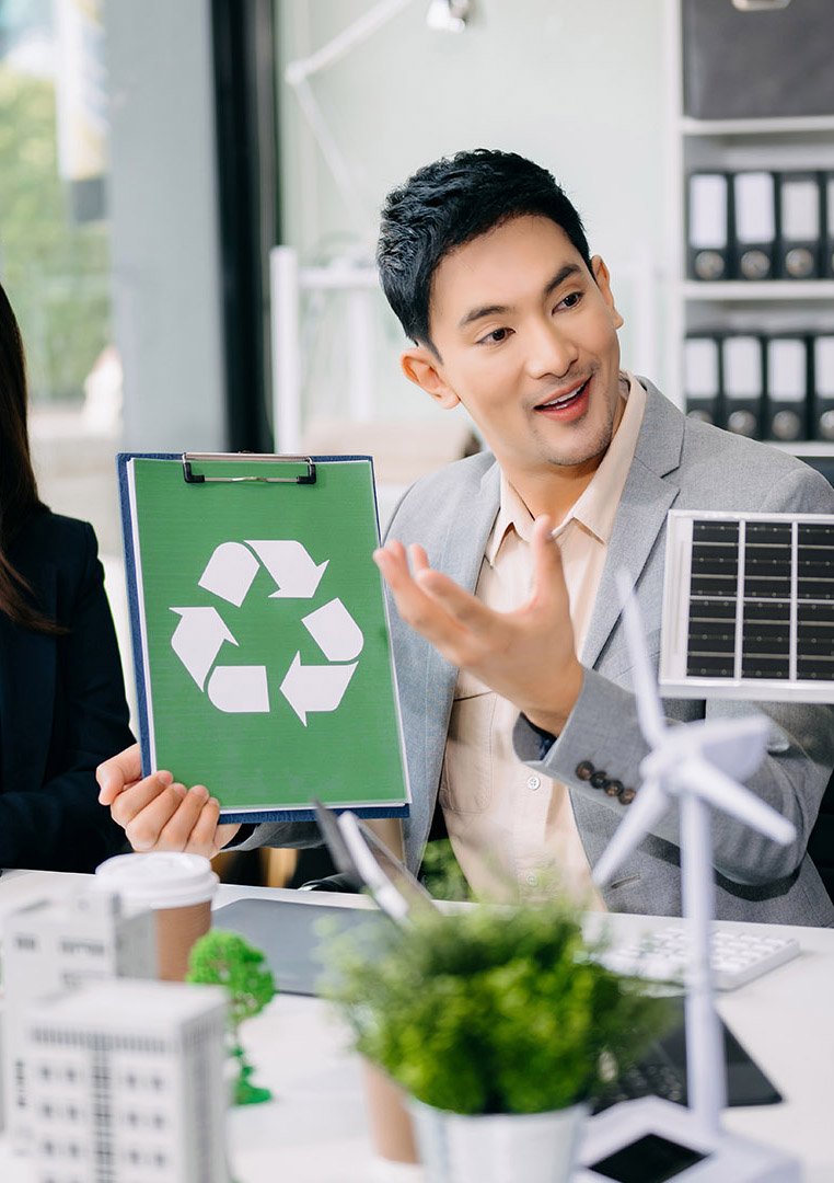 Group of diverse multiethnic businesspeople standing neare table looking at model of building from residential project. Green business company and Solar Energy Environment city Concept.