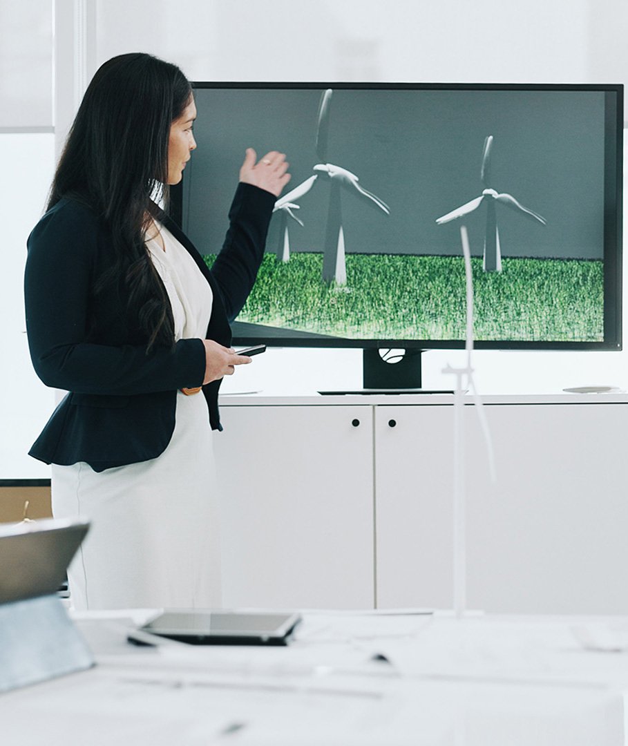 Business woman, presentation and wind turbine for eco friendly, sustainability and renewable energy.